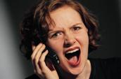 Picture depicts an employee on phone, upset with her boss.